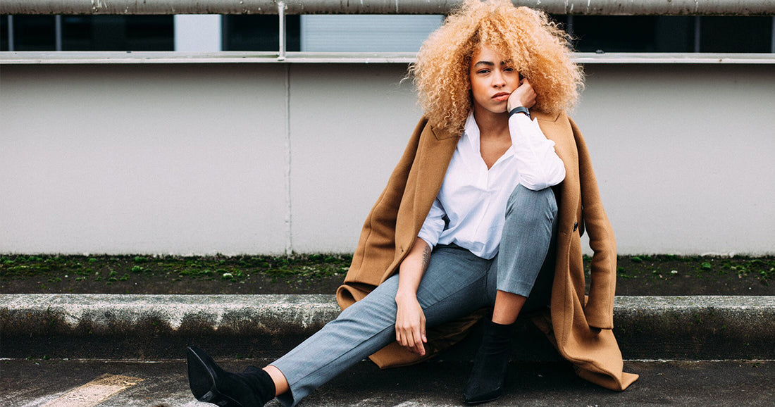 woman in bad mood sitting on curb