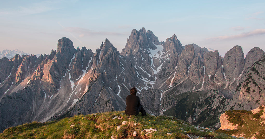 woman is witness to beauty as she sits before mountain range