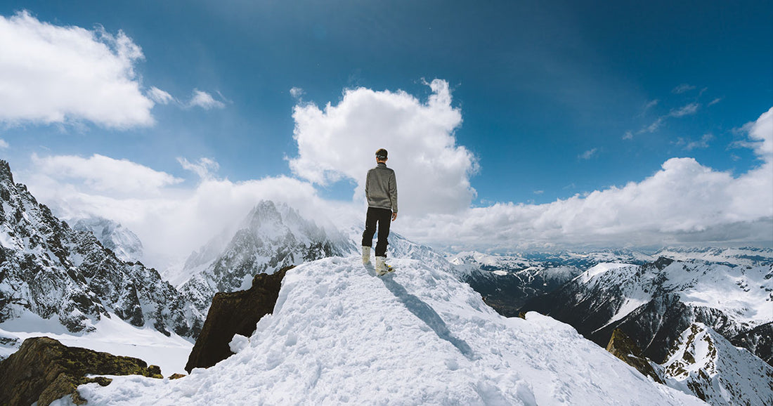 person looking at view of snowy mountains