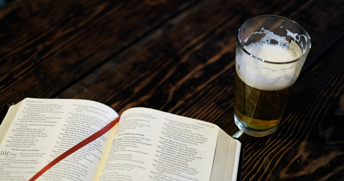 bible and a beer sitting on the table