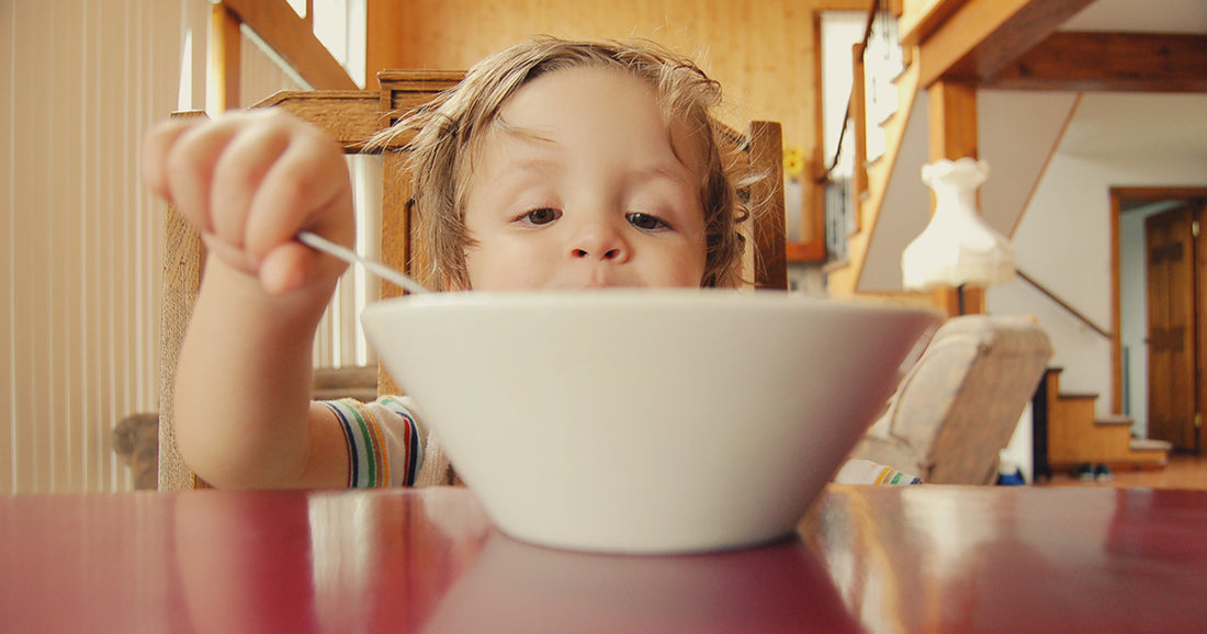 child eating breakfast in the morning