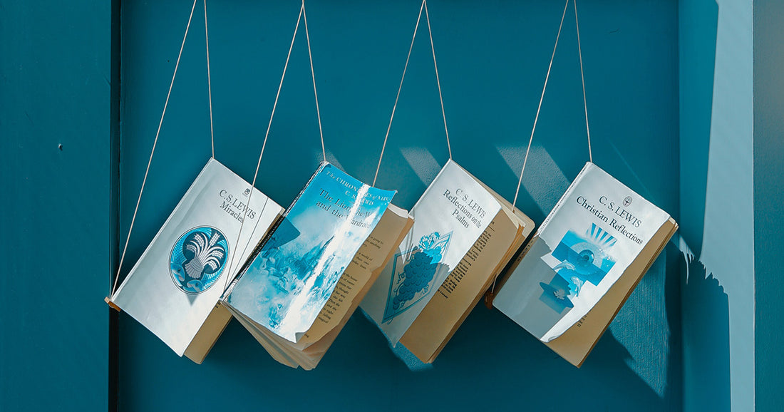 books by C.S. Lewis hanging in front of a blue wall