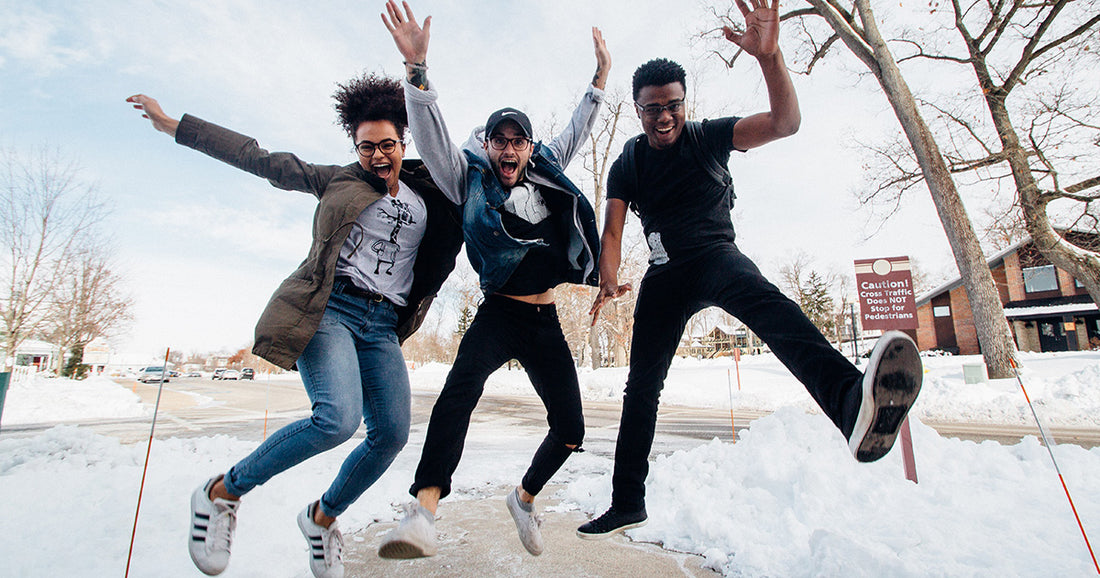 three people jumping and excited