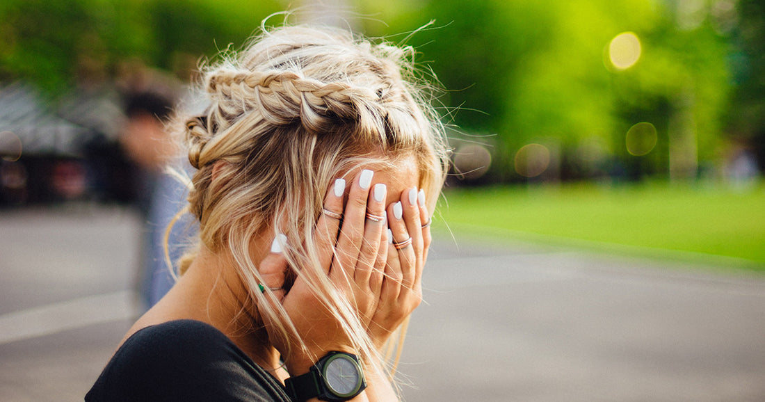 woman hiding her face in hands