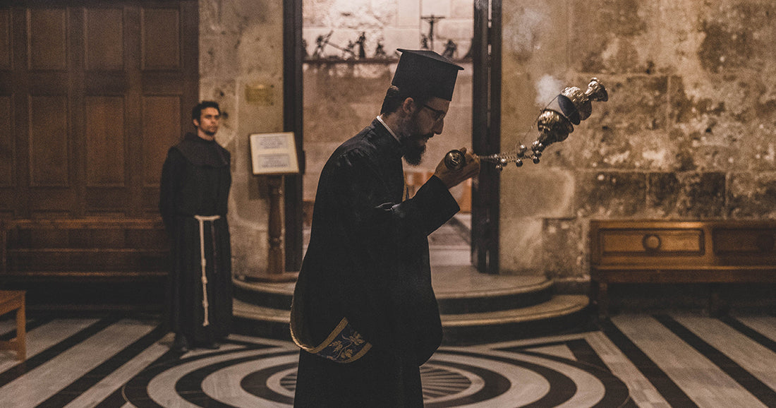 priest swinging incense
