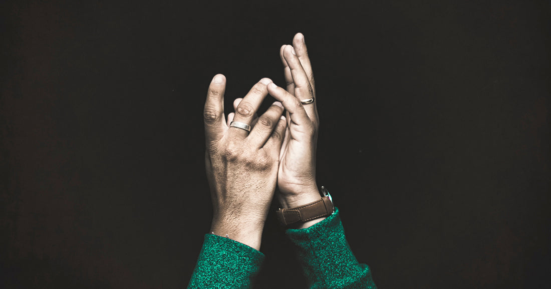 person reaching hands toward God