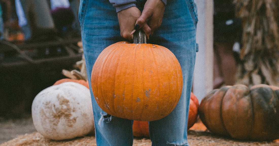 woman holding Halloween pumpkin