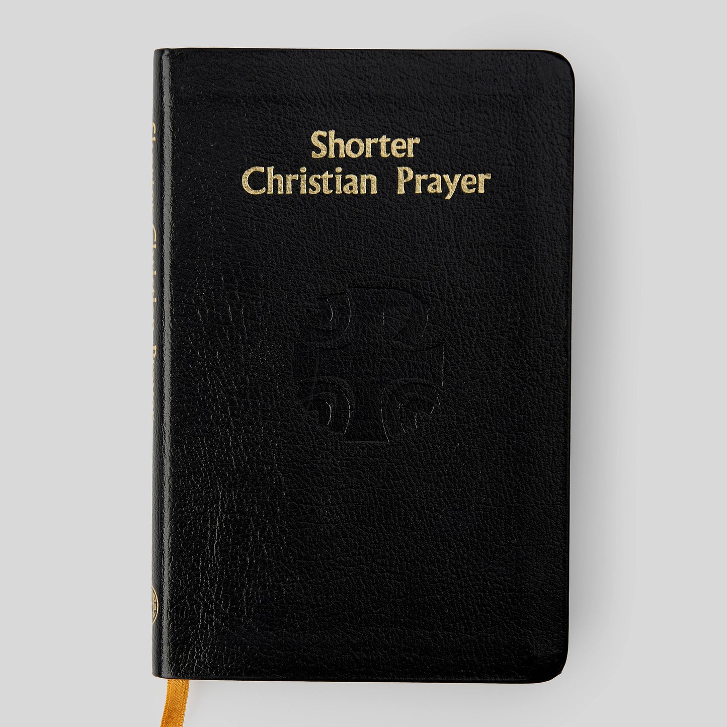 Black book titled 'Shorter Christian Prayer' on a light gray background