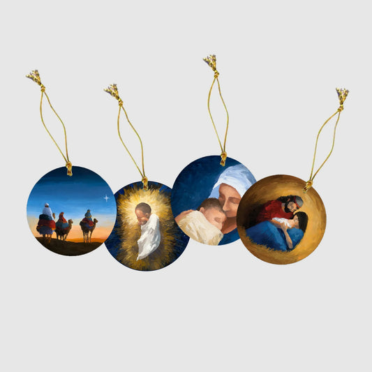 Set of four circular Christmas ornaments with religious scenes on a white background