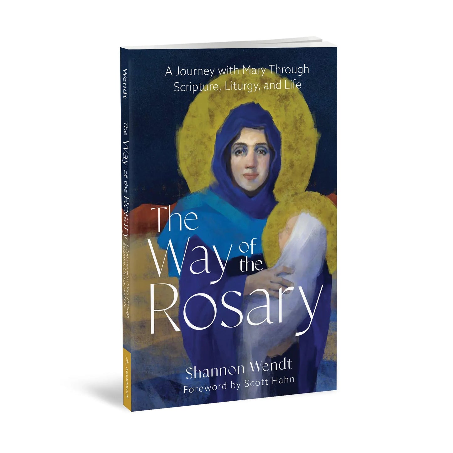 Angled view of a book cover of 'The Way of the Rosary' with a depiction of Mary holding Jesus against a dark blue background.