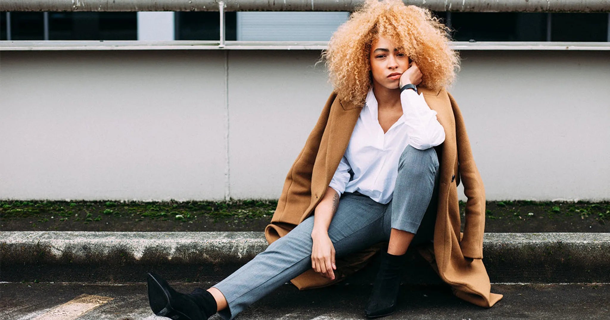 woman in bad mood sitting on curb