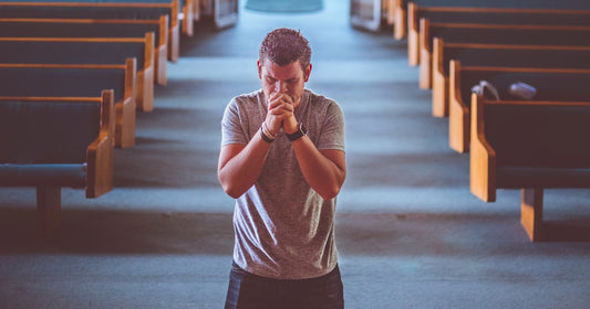 Man in a Catholic Church praying