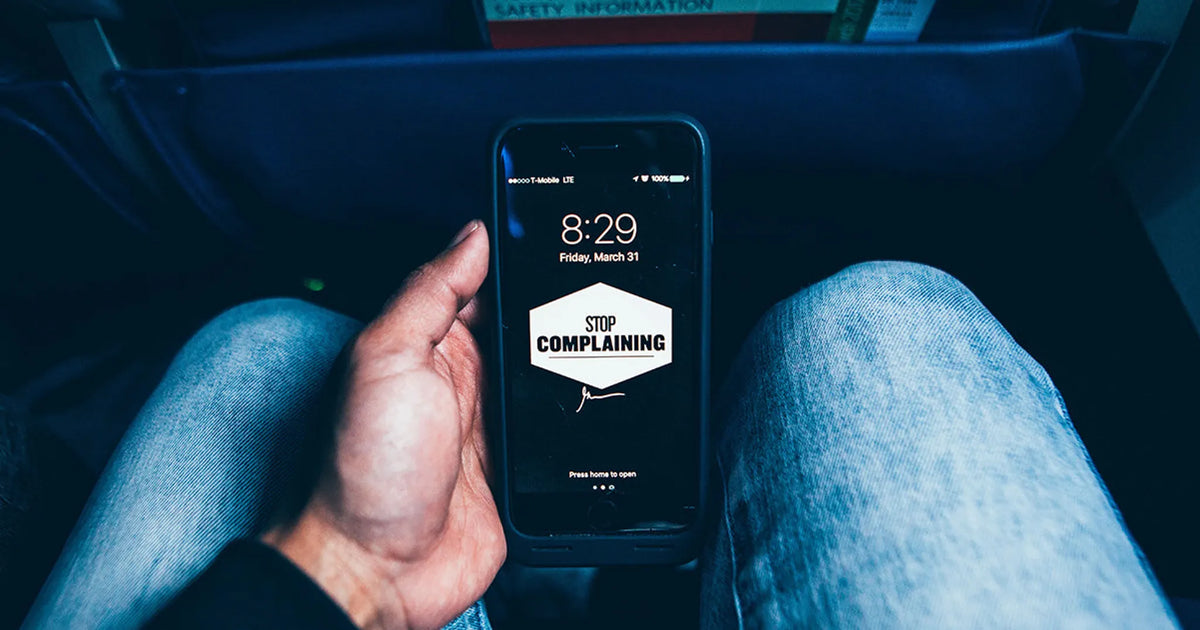 phone with text saying "stop complaining"