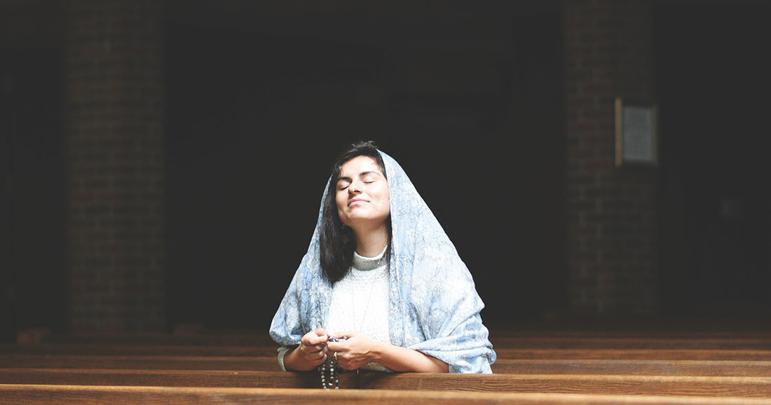 woman in church wearing a blue chapel veil