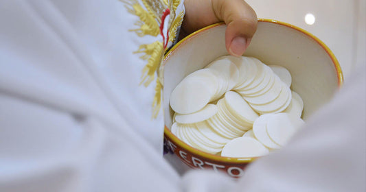 priest handing out the Eucharist during communion