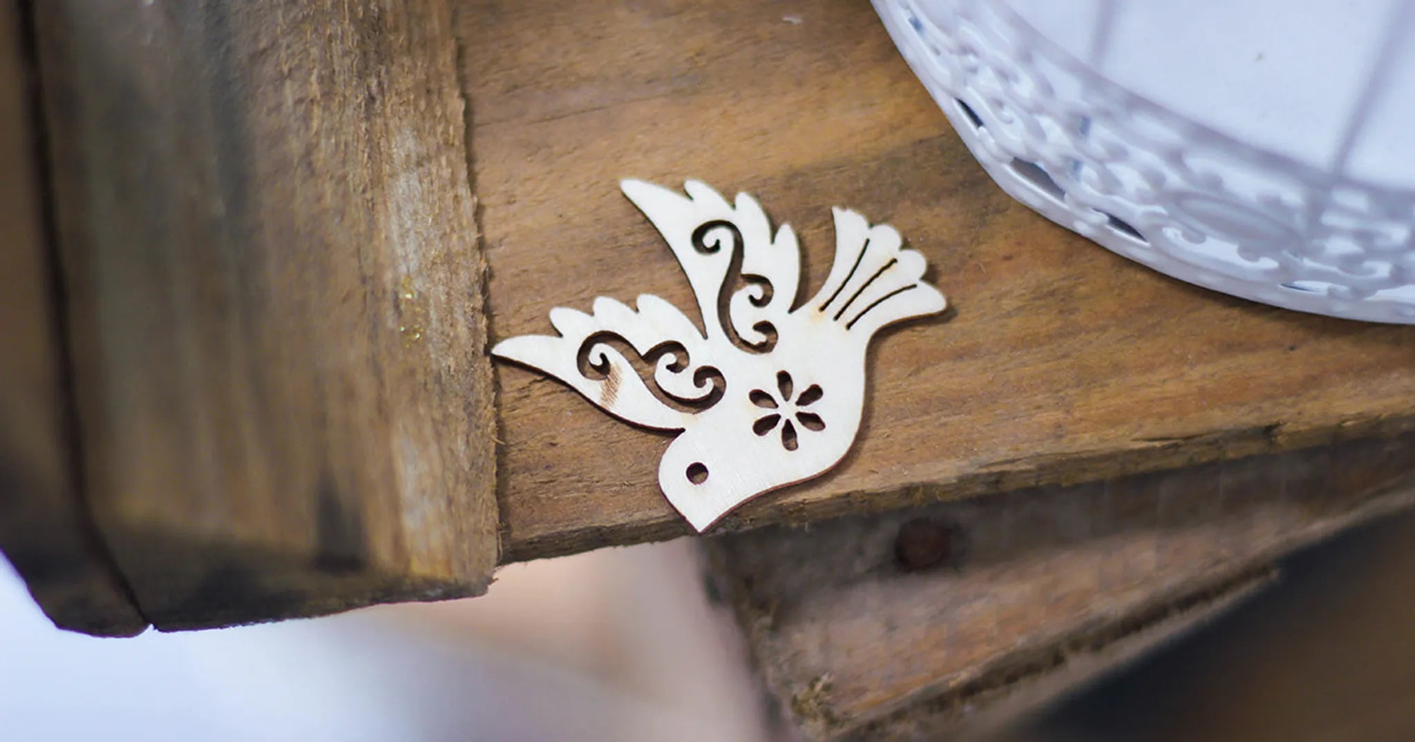 dove cutout on wooden table