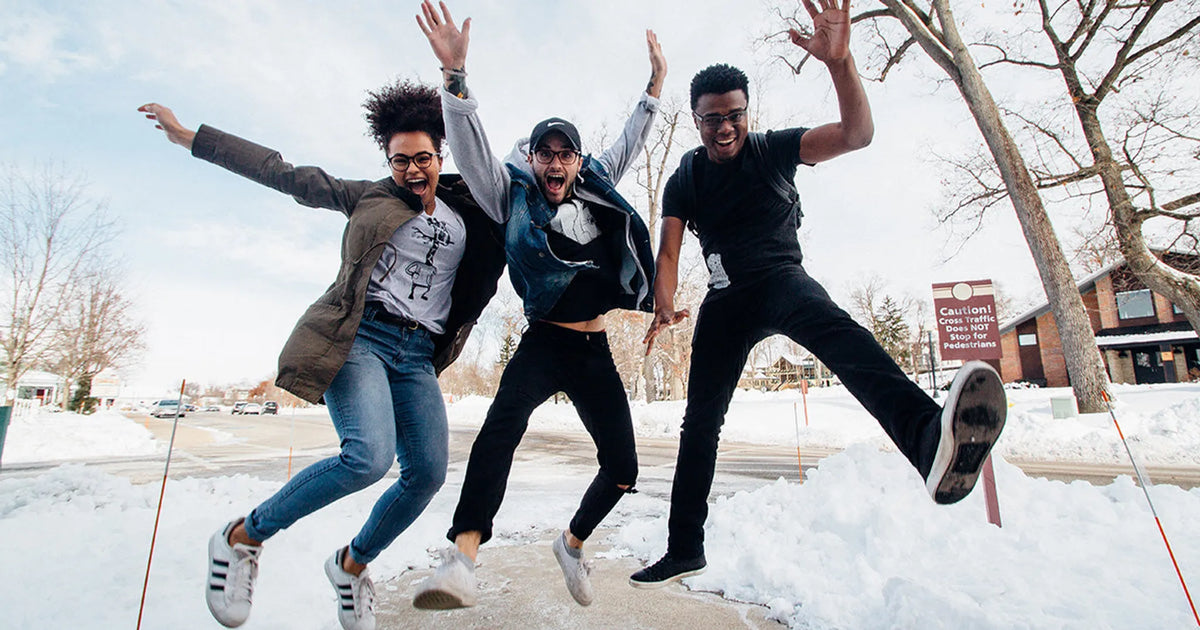 three people jumping and excited