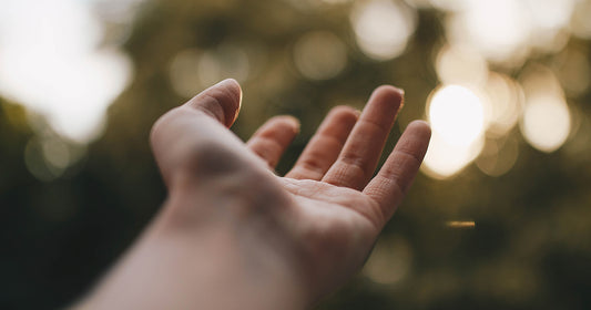 hand reaching out with blurred background