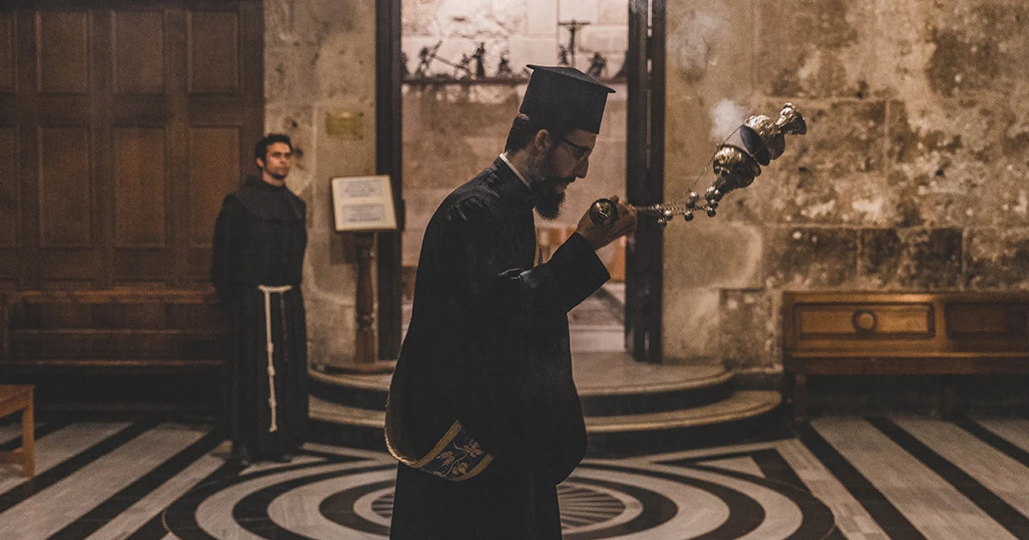 priest swinging incense