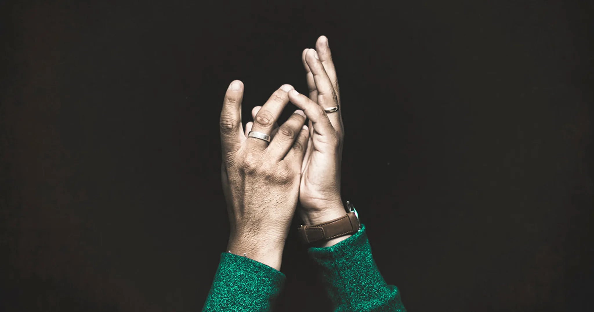 person reaching hands toward God