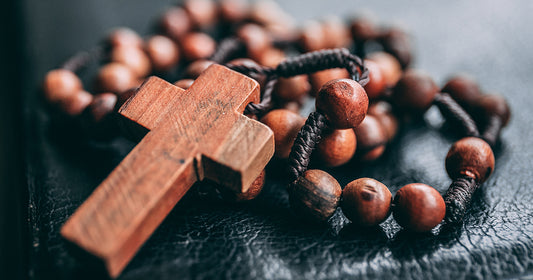 rosary sits on catholic bible