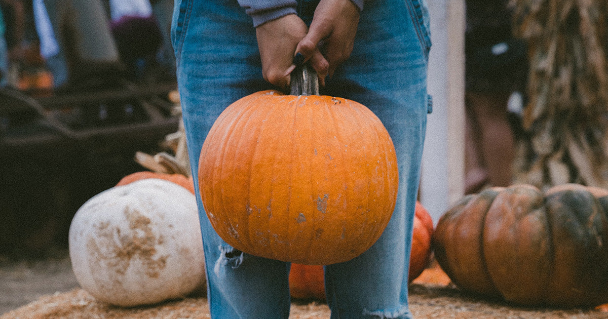 woman holding Halloween pumpkin