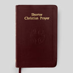 Red book titled 'Shorter Christian Prayer' on a light gray background
