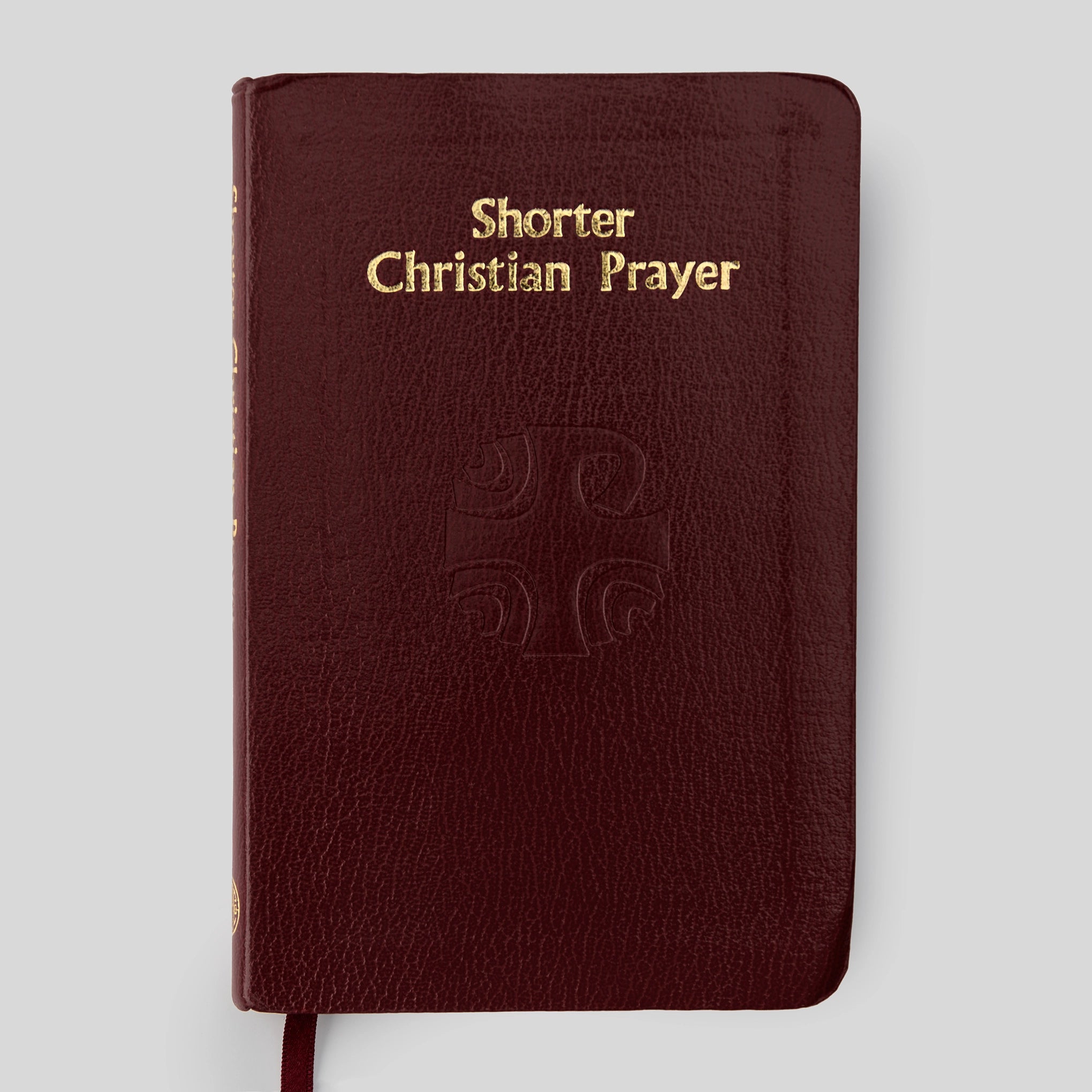 Red book titled 'Shorter Christian Prayer' on a light gray background
