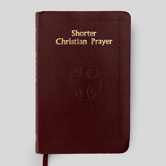 Red book titled 'Shorter Christian Prayer' on a light gray background
