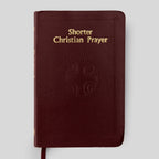 Red book titled 'Shorter Christian Prayer' on a light gray background
