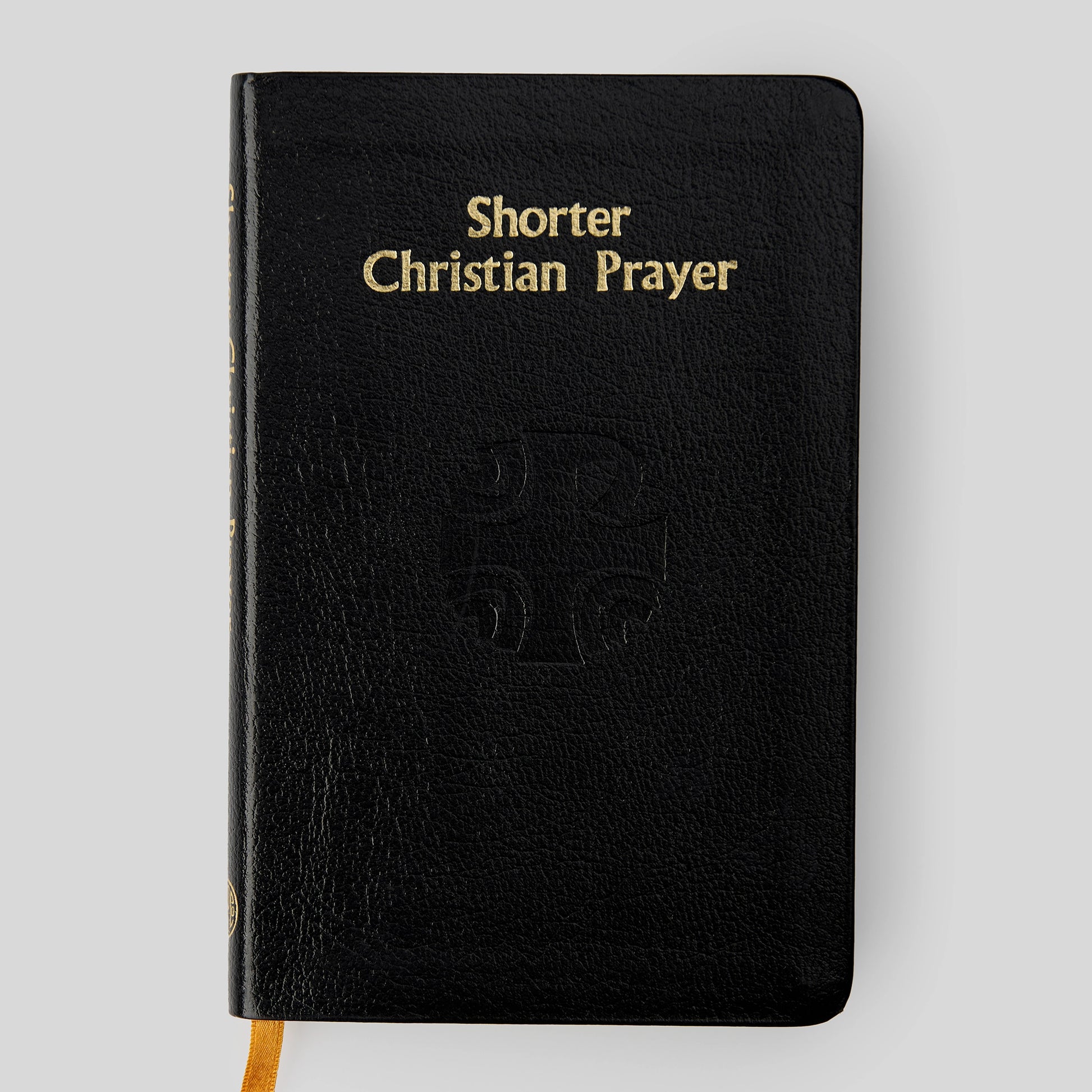 Black book titled 'Shorter Christian Prayer' on a light gray background