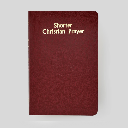 Red book titled 'Shorter Christian Prayer' on a light gray background
