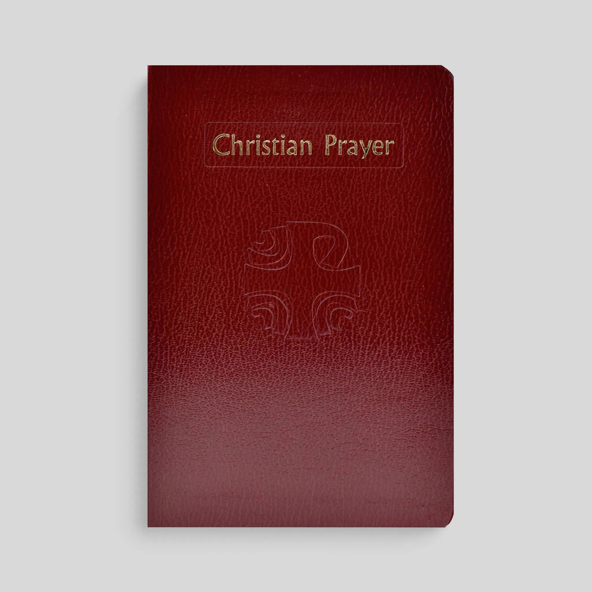 Red leather prayer book with 'Christian Prayer' and a cross on the cover