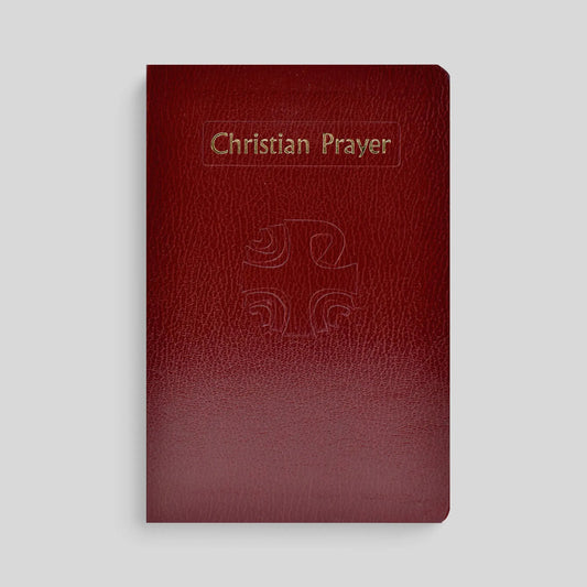 Red leather prayer book with 'Christian Prayer' and a cross on the cover